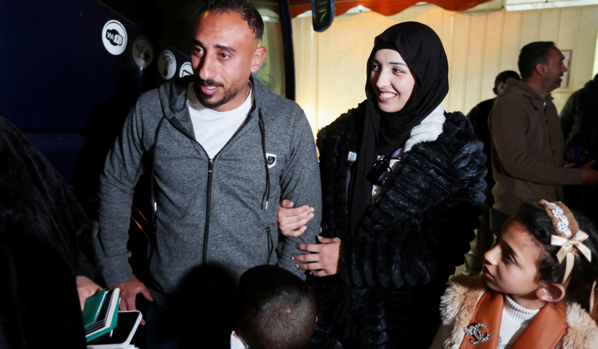 Palestinian mother of three, Eatedal Rayyan, 29, reunites with her husband, Ahmed Rayyan, as she returns to Gaza with their children after she received medical treatment in Egypt, following nearly two years away from Gaza, at Nasser Hospital in Khan Younis in the southern Gaza Strip, February 5, 2026. (REUTERS)