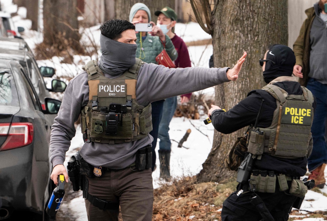 Observers film ICE agents as they hold a perimeter after one of their vehicles got a flat tire on Penn Avenue in Minneapolis, US. (Getty)