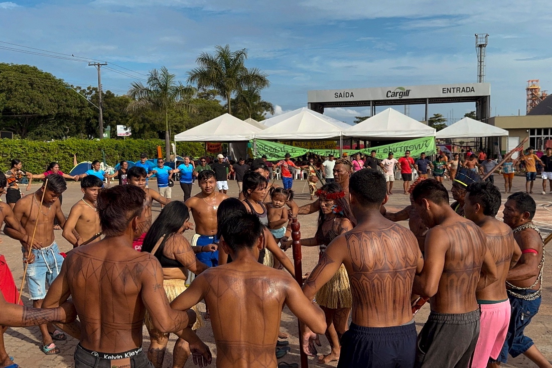 A group of indigenous people dancing during a protest in front of the port terminal of US agribusiness giant Cargill located in the city of Santarem, Para state, Brazil. (Amazon Watch NGO)