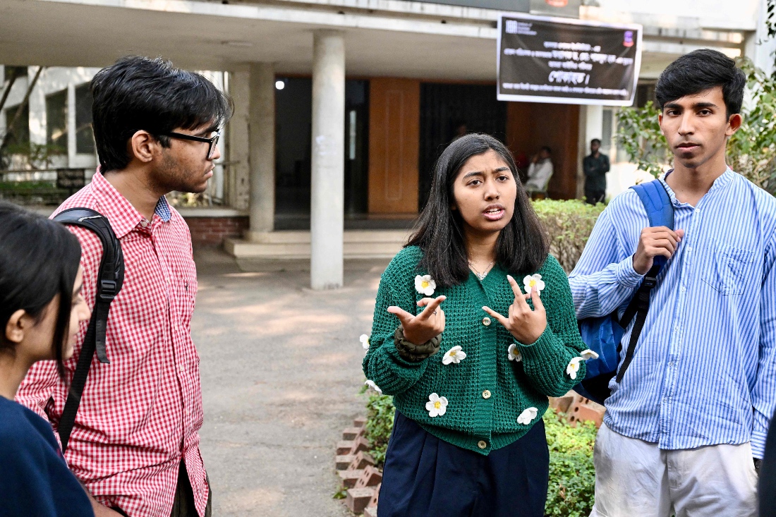 Dhaka University student and first-time voter Ariana Rahman talking to her friends inside their campus in Dhaka, Bangladesh. (AFP)