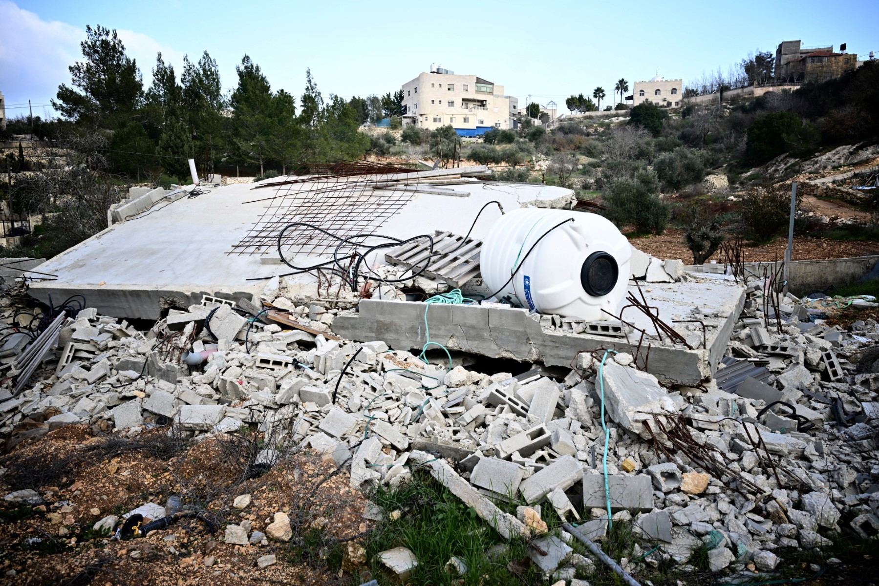 A toppled water tank and concrete debris from a flattened Palestinian home in Al-Walaja, a village in annexed East Jerusalem. (File / AFP)
