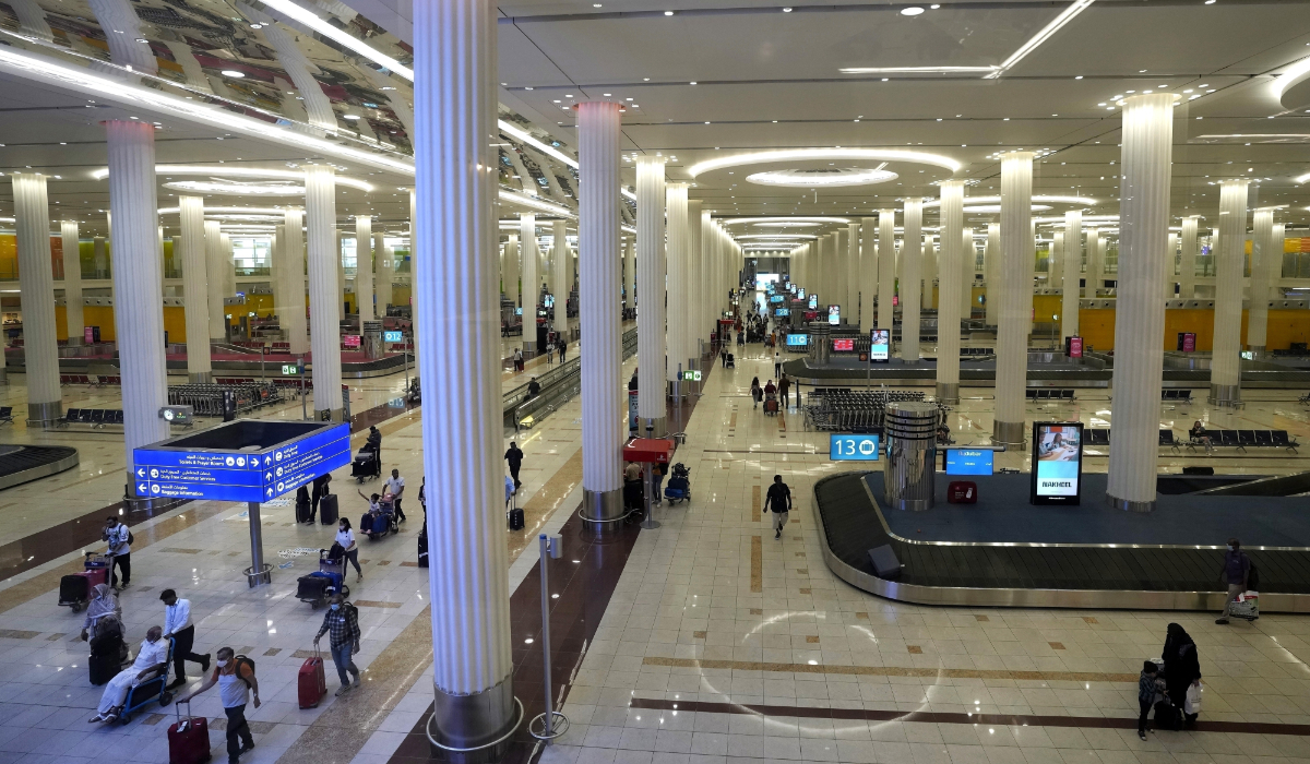 Passengers leave the baggage handling hall at the Dubai International Airport terminal 3, in Dubai, United Arab Emirates, on Oct. 25, 2022. (AP)