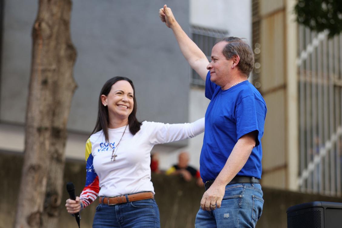 Former Deputy of the National Assembly of Venezuela, Juan Pablo Guanipa (R), gestures next to Venezuelan opposition leader Maria Corina Machado during a protest called by the opposition on the eve of the presidential inauguration in Caracas on January 9, 2025. Juan Pablo Guanipa, an opposition figure close to Nobel Peace Prize laureate Maria Corina Machado, was released on February 8, 2026. (Photo by Pedro MATTEY / AFP)