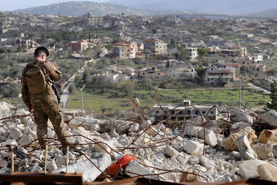 A members of the Lebanese military stands guard during a visit by Lebanon's prime minister to the heavily-damaged southern village of Kfar Kila, destroyed by the Israeli military, near the border with Israel on February 8, 2026. (AFP)