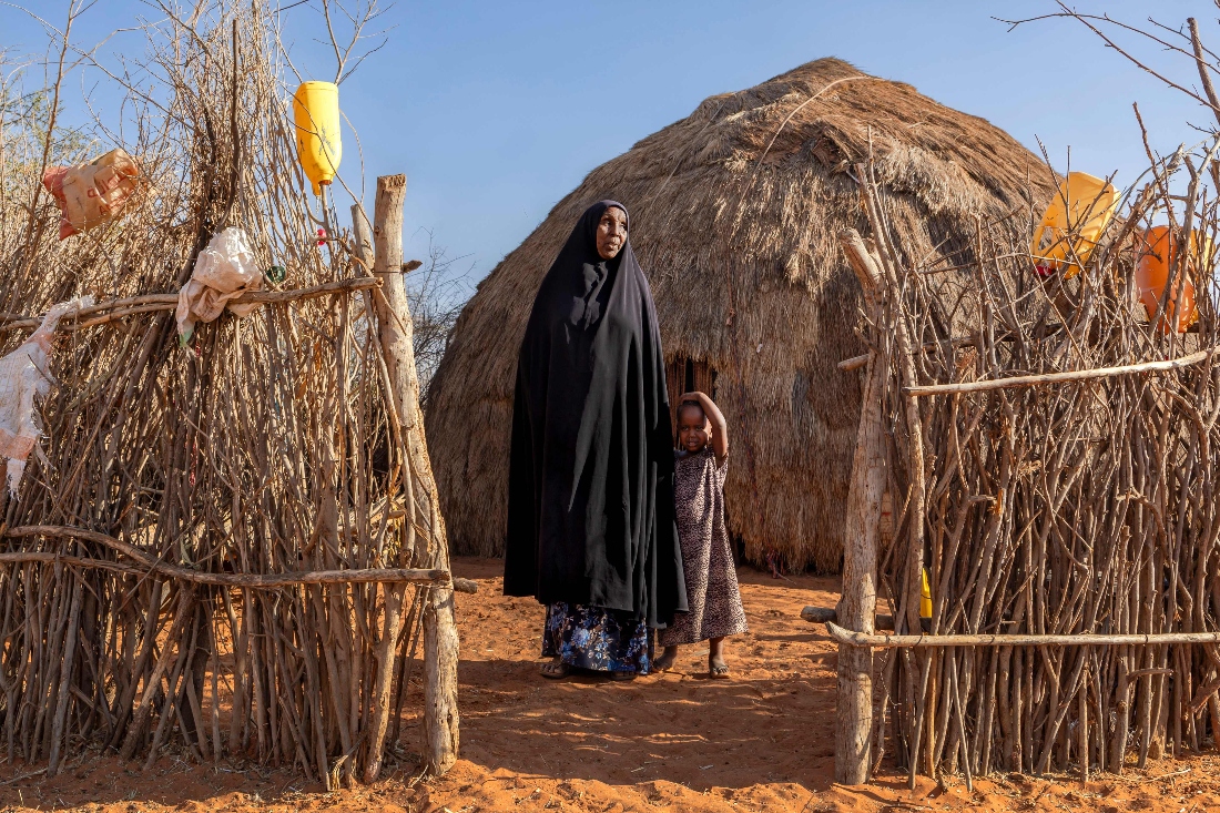 Kala-azar survivor Harada Hussein Abdirahman stands with her granddaughter in her compound in a village adjacent to one of the stone quarry areas in the hills outside Mandera town, Kenya. (AFP)