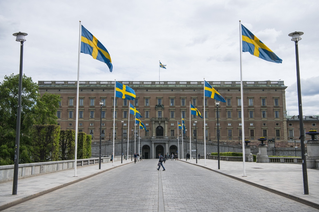 Swedish flags fly in front of the Royal Palace in Stockholm, Sweden. (AFP)