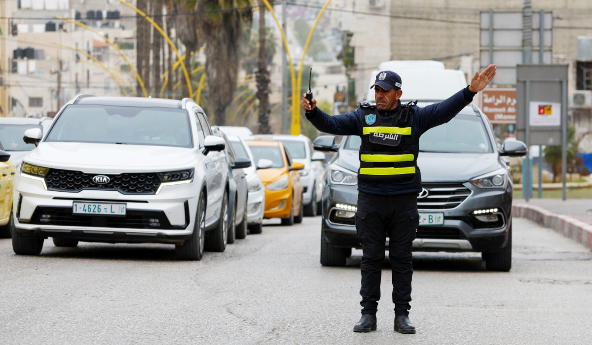 A Palestinian policeman directs the traffic in Hebron in the Israeli-occupied West Bank, February 9, 2026. (REUTERS)