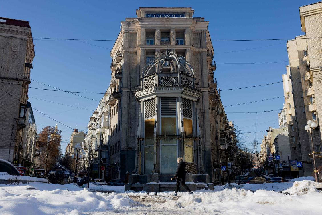 A pedestrian walks down a snow-covered street in the centre of Kyiv on February 9, 2026, amid the Russian invasion of Ukraine. (AFP)