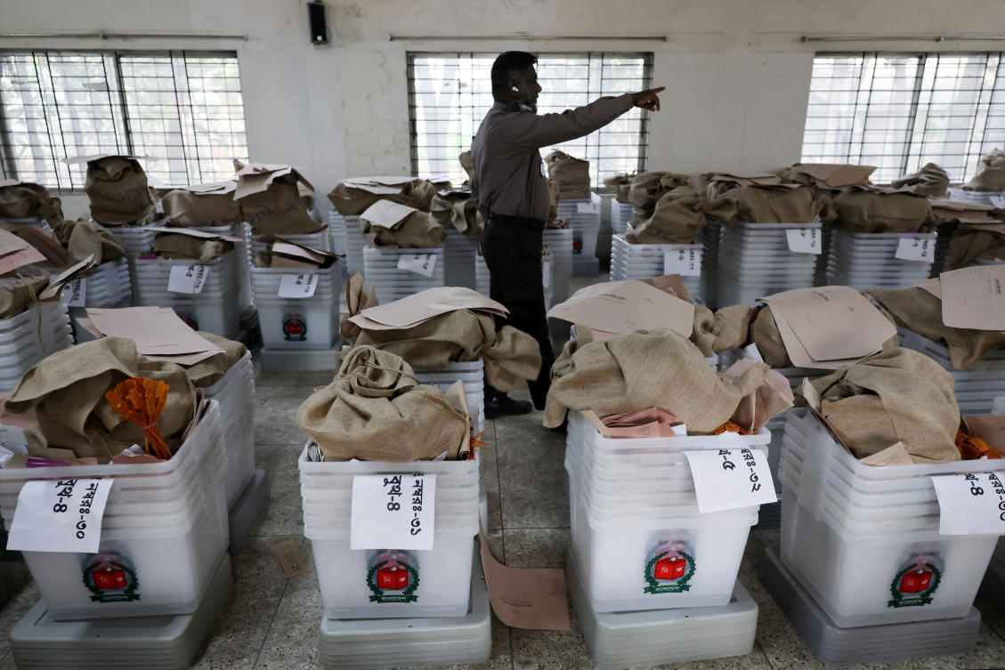 A police officer stands guard in a room full of ballot boxes, before dispatching them to voting centres, ahead of the national election, in Dhaka, Bangladesh, February 10, 2026. (Reuters)
