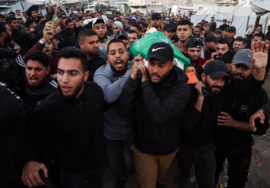 Mourners carry the bodies of Palestinians killed by an Israeli strike on Monday, during their funeral in Gaza City on Tuesday. (Reuters)