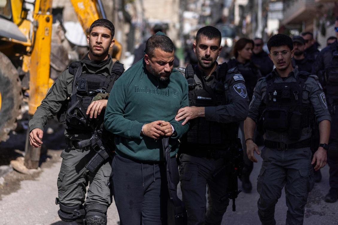 Israeli security forces detain a Palestinian man during the demolition of structures in the Al-Bustan area of the Palestinian neighborhood of Silwan, in Israeli-annexed east Jerusalem, on February 10, 2026. (AFP)