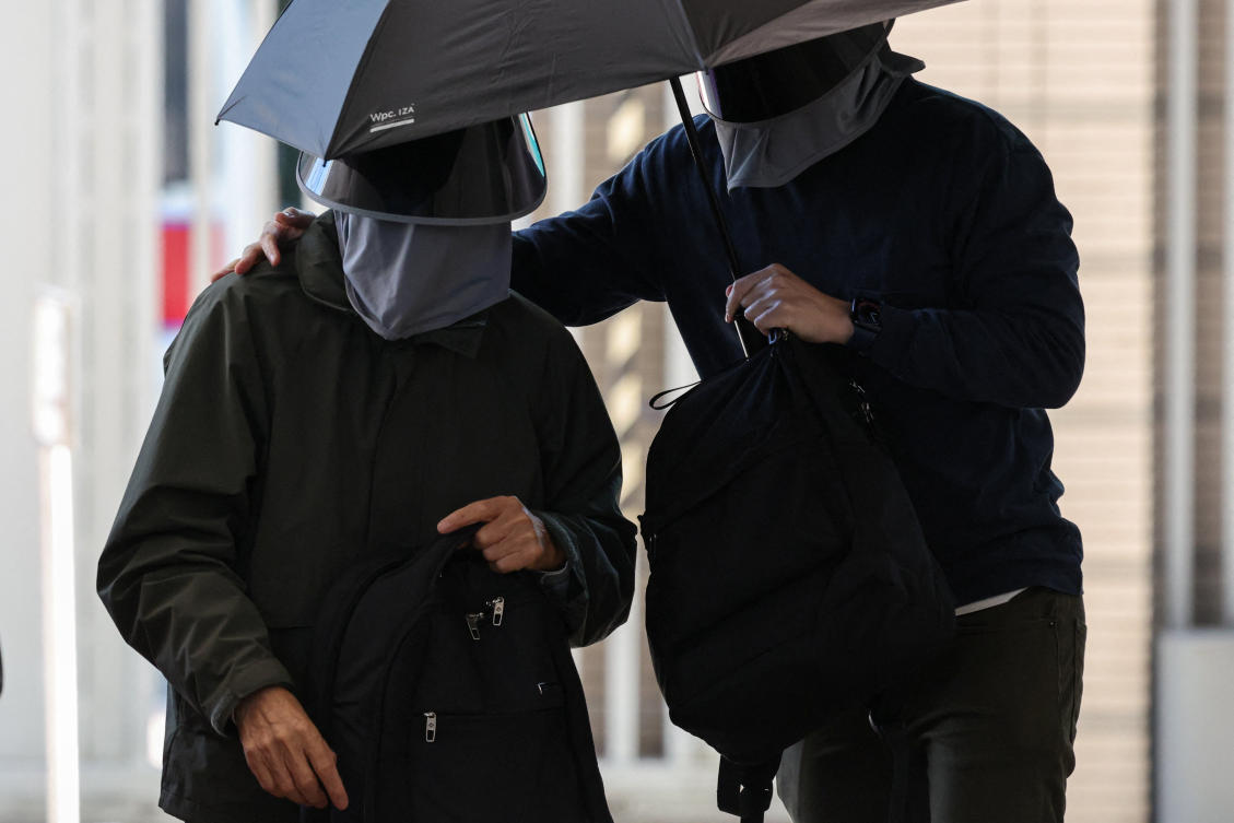 Kwok Yin-sang, left, is the first person to be charged under a Hong Kong law known as Article 23 that expands on a Beijing-imposed national security law. (Reuters)