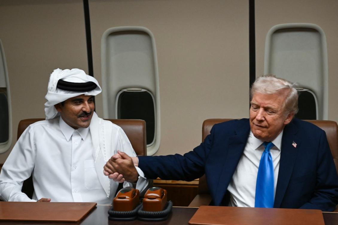US President Donald Trump greets Qatar’s Emir Sheikh Tamim bin Hamad Al-Thani (L) during a meeting aboard Air Force One in Doha on October 25, 2025, as he makes a refuelling stop on his way to Malaysia for the ASEAN summit. (FILE/AFP)