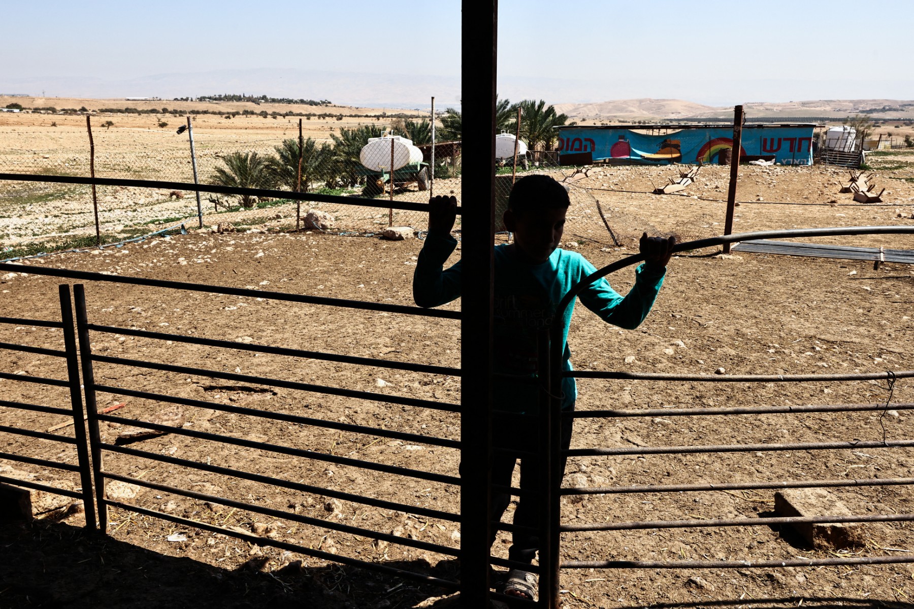 A boy from the bedouin community of al-Auja looks at an empty sheepfold after sheep were reportedly stolen by Israeli settlers in an attack, west of Jericho in the Israel-occupied West Bank. (File / AFP)