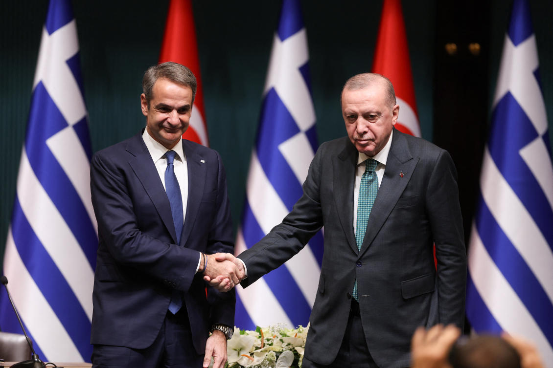 Turkish President Tayyip Erdogan and Greek Prime Minister Kyriakos Mitsotakis shake hands during a joint press conference at the Presidential Palace in Ankara on Wednesday. (Reuters)