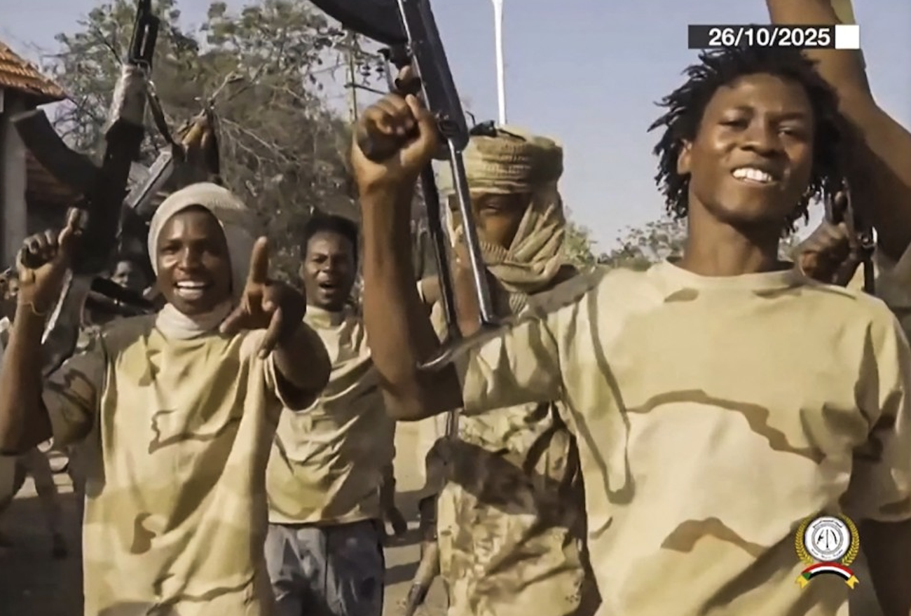 RSF fighters hold weapons and celebrate in the streets of El-Fasher in Sudan's Darfur. (File/AFP)