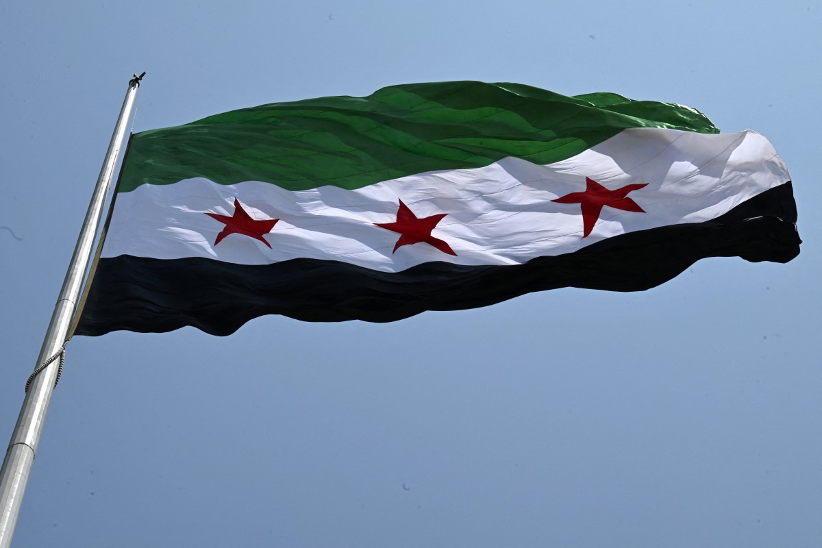 A large Syrian flag flutters above Tishreen Park in Damascus. (File / AFP)