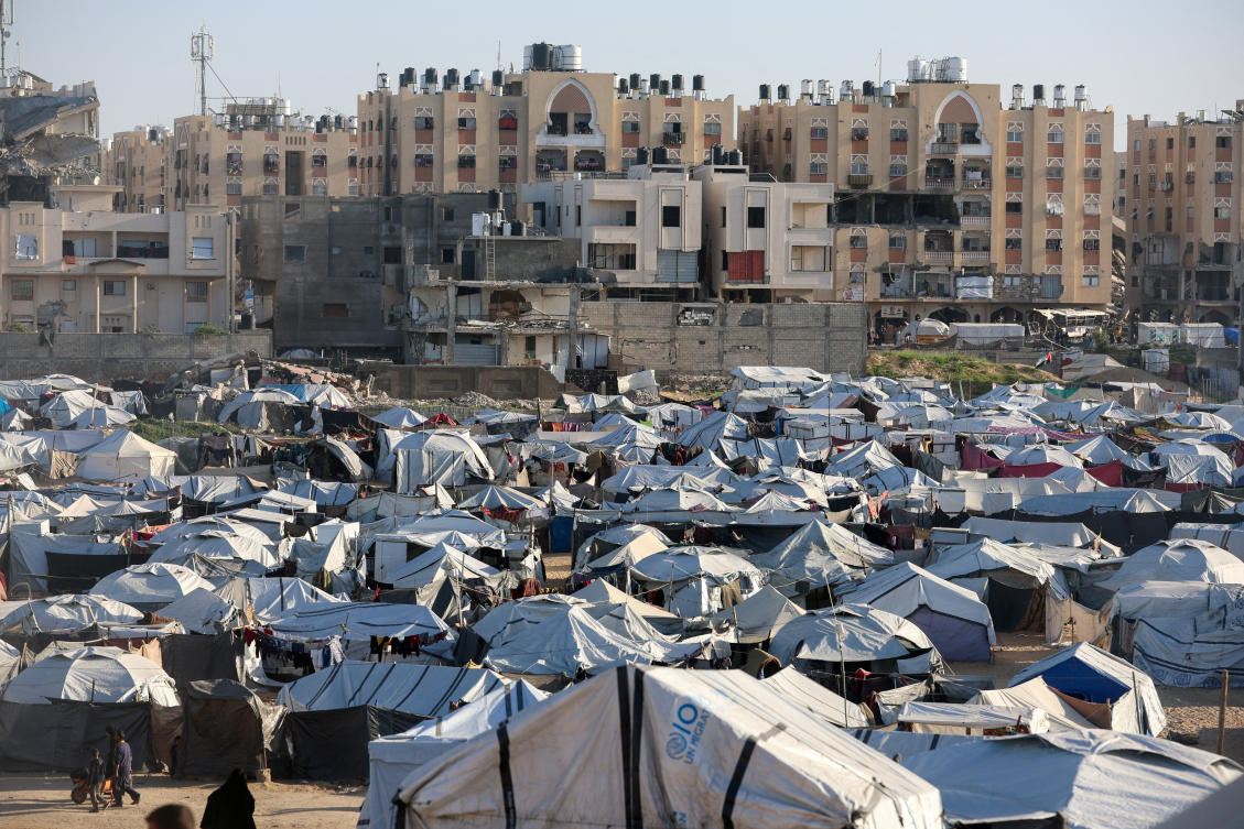 Palestinians displaced during the two-year Israeli offensive shelter at a tent camp in Khan Younis in the southern Gaza Strip, February 10, 2026. (Reuters)