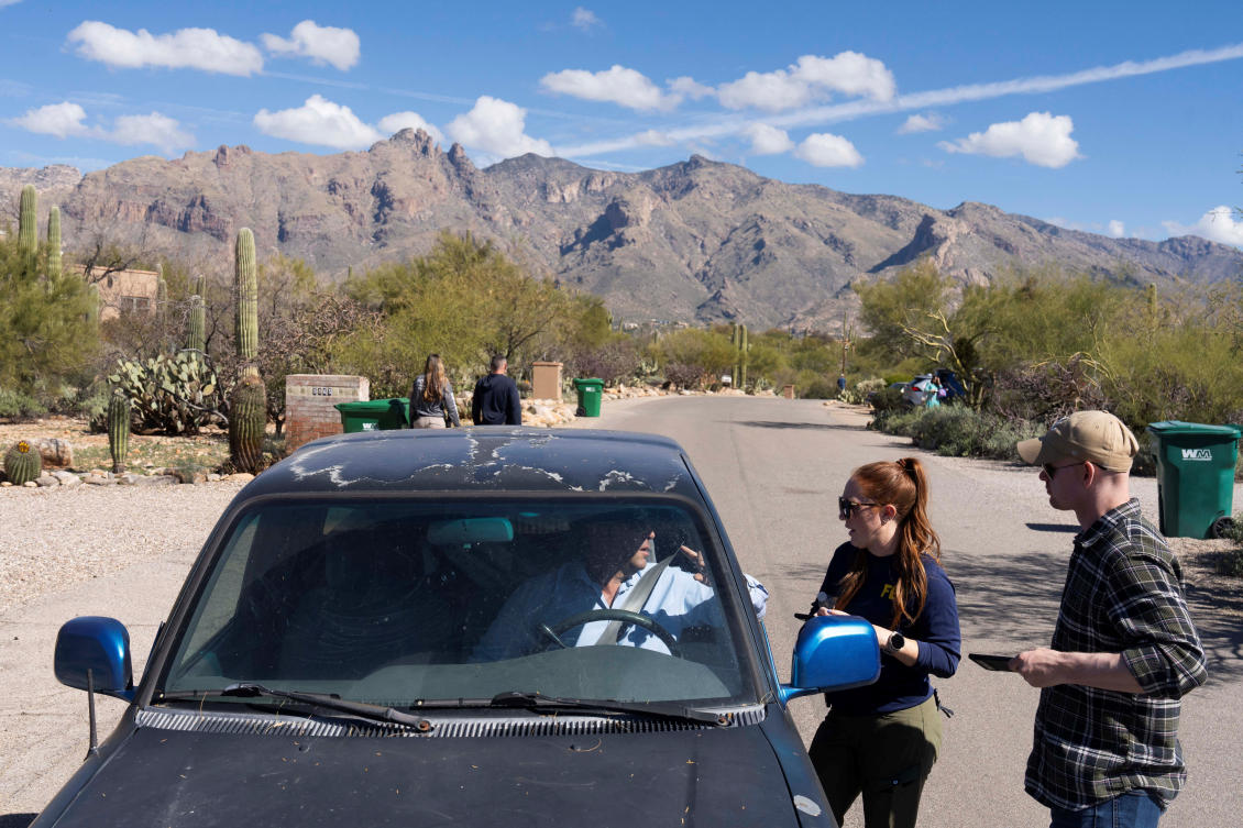 Investigators speak with a local property owner while searching the area near Nancy Guthrie’s home in the Catalina Foothills in Tucson, Arizona on Feb. 11, 2026. (Reuters)