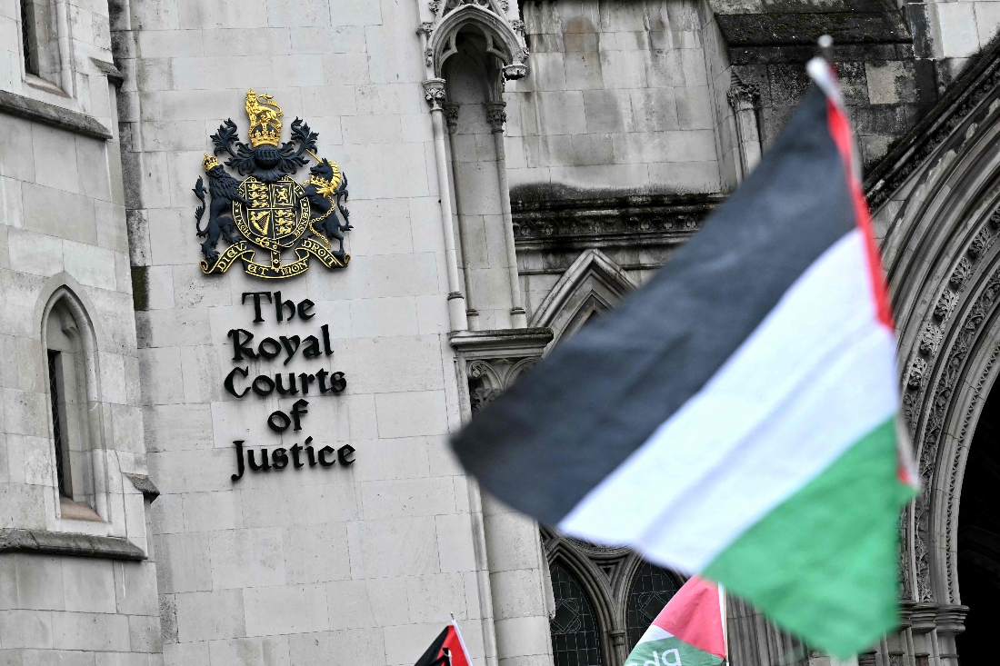 A Palestinian flag is flown by a protestor outside The Royal Courts of Justice, Britain's High Court, in London, UK. (AFP)