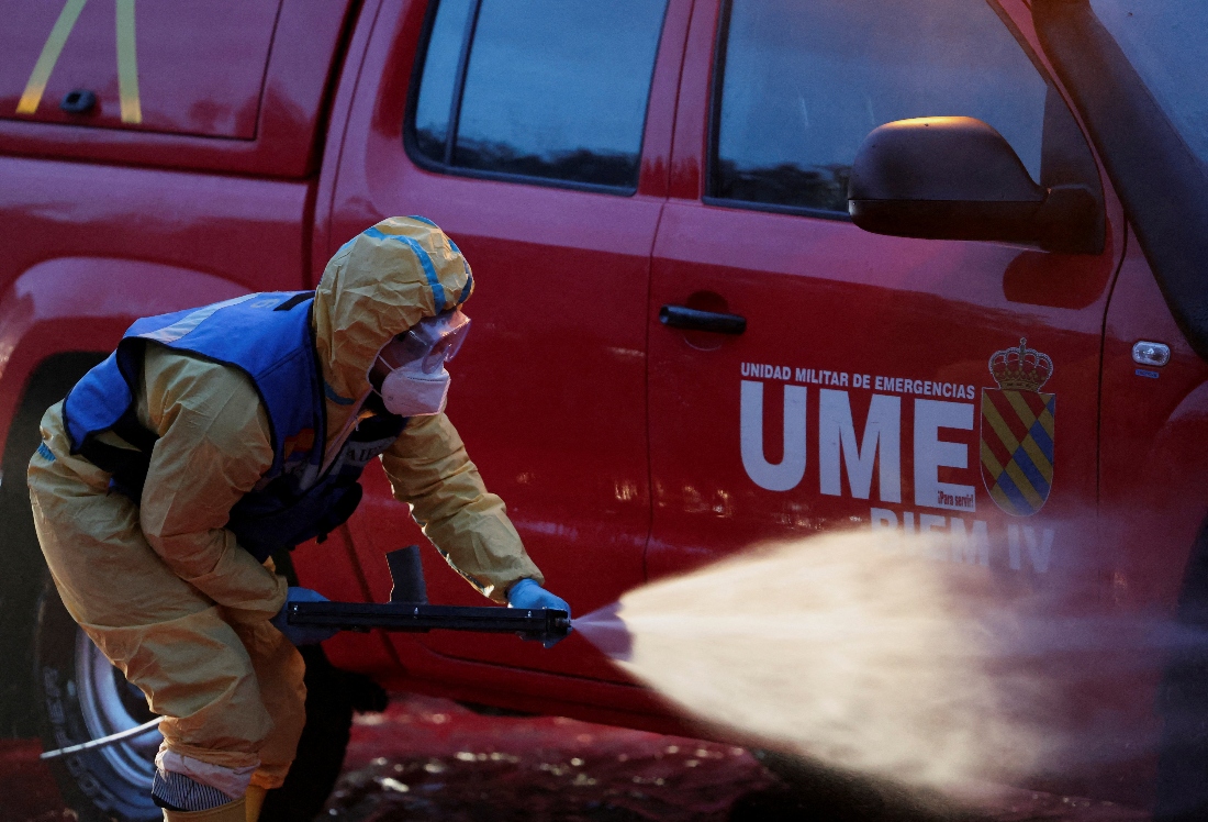 A member of UME (Spanish Emergency military unit) disinfects a vehicle after working in a restricted area due to the African swine fever virus, at Collserola Park in Cerdanyola del Valles, on the outskirts of Barcelona, Spain. (Reuters)