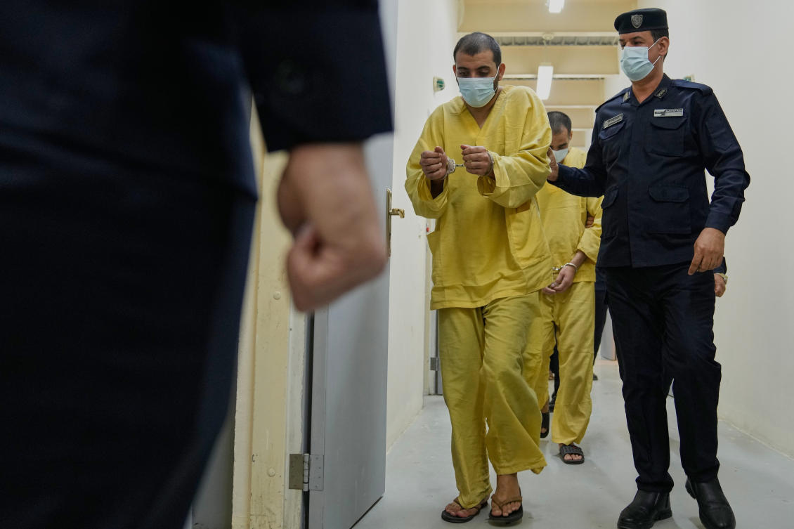 Iraqi security forces lead suspected Daesh militants for questioning, after they were transferred from Syria to Iraq, at Al-Karkh Central Prison in Baghdad on Thursday. (AP)