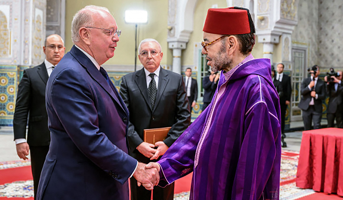 Morocco's King Mohammed VI (R) shakes hands with the Chairman of Safran Ross McInnes, at the Royal Palace in Casablanca on February 13, 2026. (AFP)