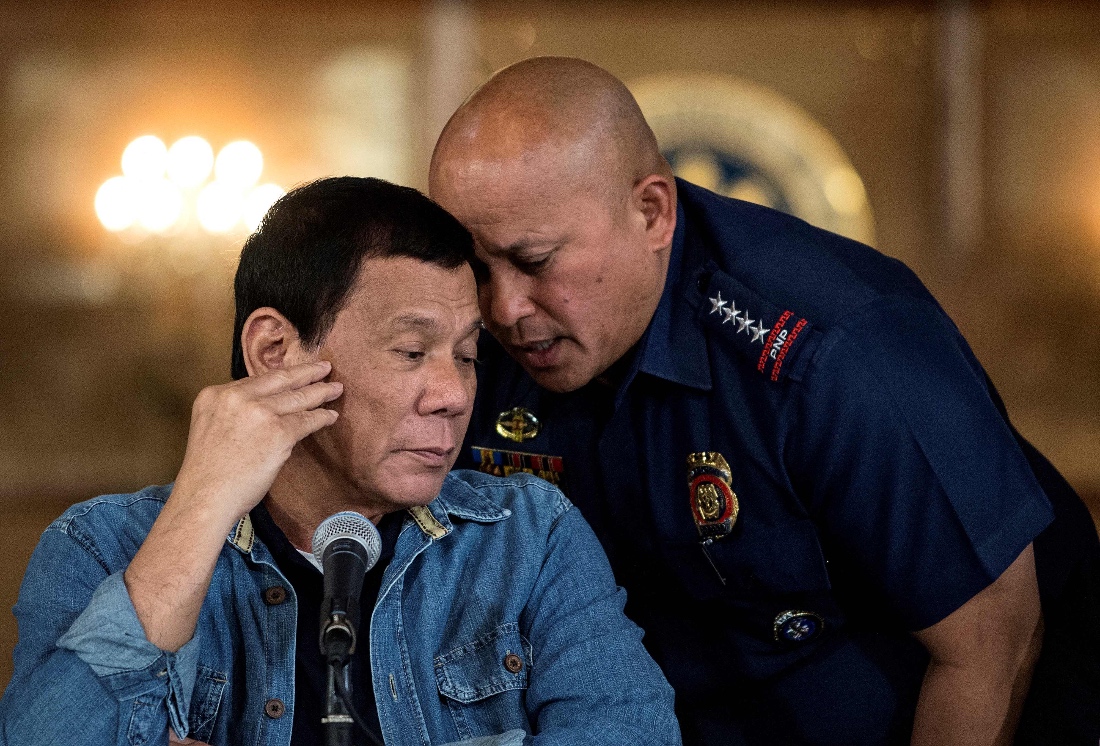 A photo dated January 2017 shows Philippine President Rodrigo Duterte listening to Ronald Dela Rosa, then-director general of the Philippine National Police, during a press conference at the Malacanang palace in Manila, Philippine. (AFP)
