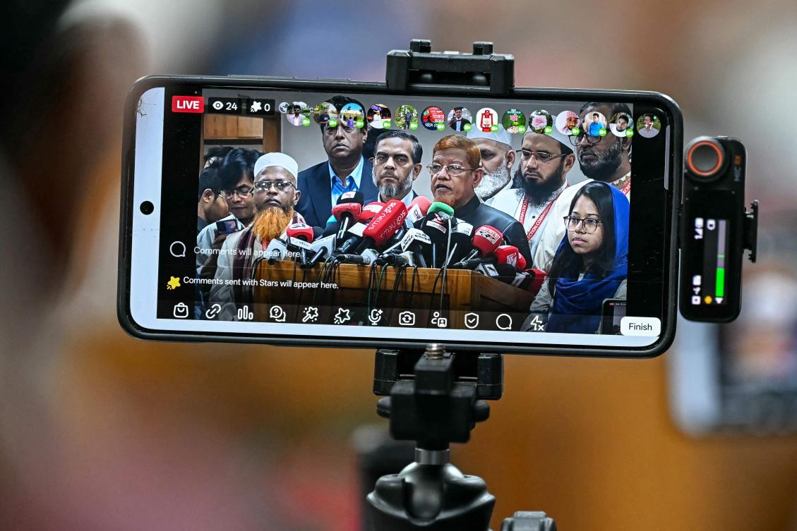 Bangladesh Jamaat-e-Islami party’s leader Hamidur Rahman Azad, center, addresses the media after a meeting with election officials in Dhaka on Feb. 15, 2026. (AFP)