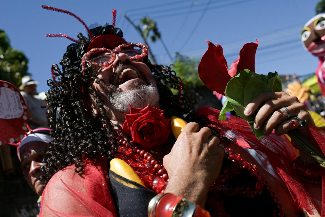 Revelers take part in the 'Carmelitas' block party during a Carnival parade, in Rio de Janeiro, Brazil February 13, 2026. (REUTERS/Tita Barros)