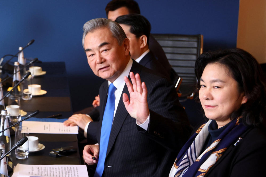 Chinese Foreign Minister Wang Yi gestures as he meets with German Chancellor Friedrich Merz at the Munich Security Conference in Munich, Germany, on Feb. 14, 2026. (Pool Photo via AP)