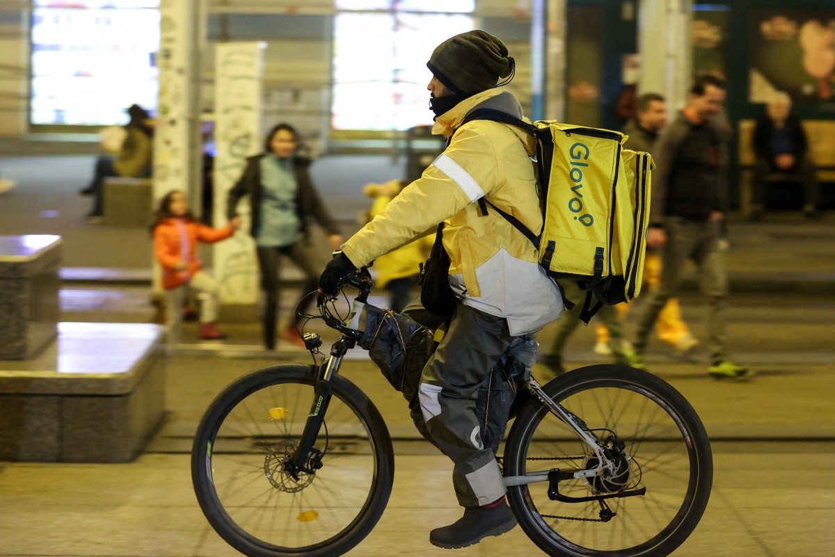 A foreign delivery worker rides a bicycle in downtown Zagreb, Croatia. (AFP)