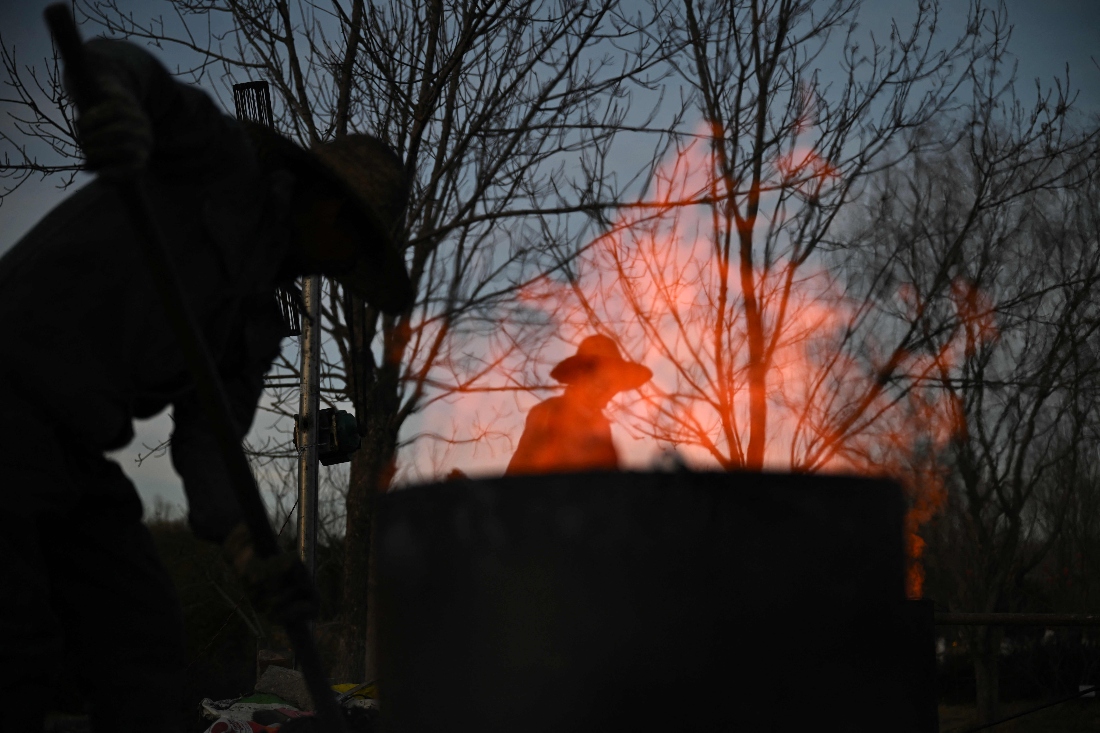 Men prepare for a molten iron fireworks performance in a park ahead of the Lunar New Year of the Horse in Beijing, China. (AFP)