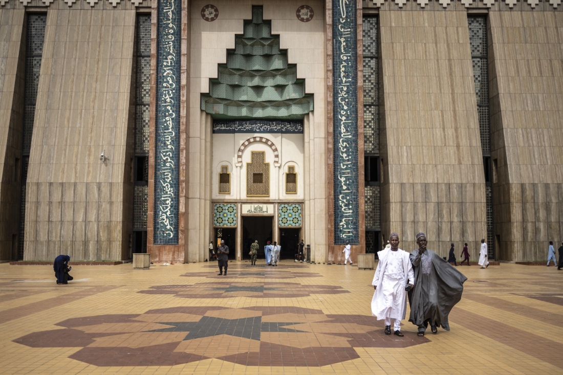 Muslim worshippers walk out of Abuja National Mosque after attending the Friday prayers in Abuja, Nigeria. (AFP)