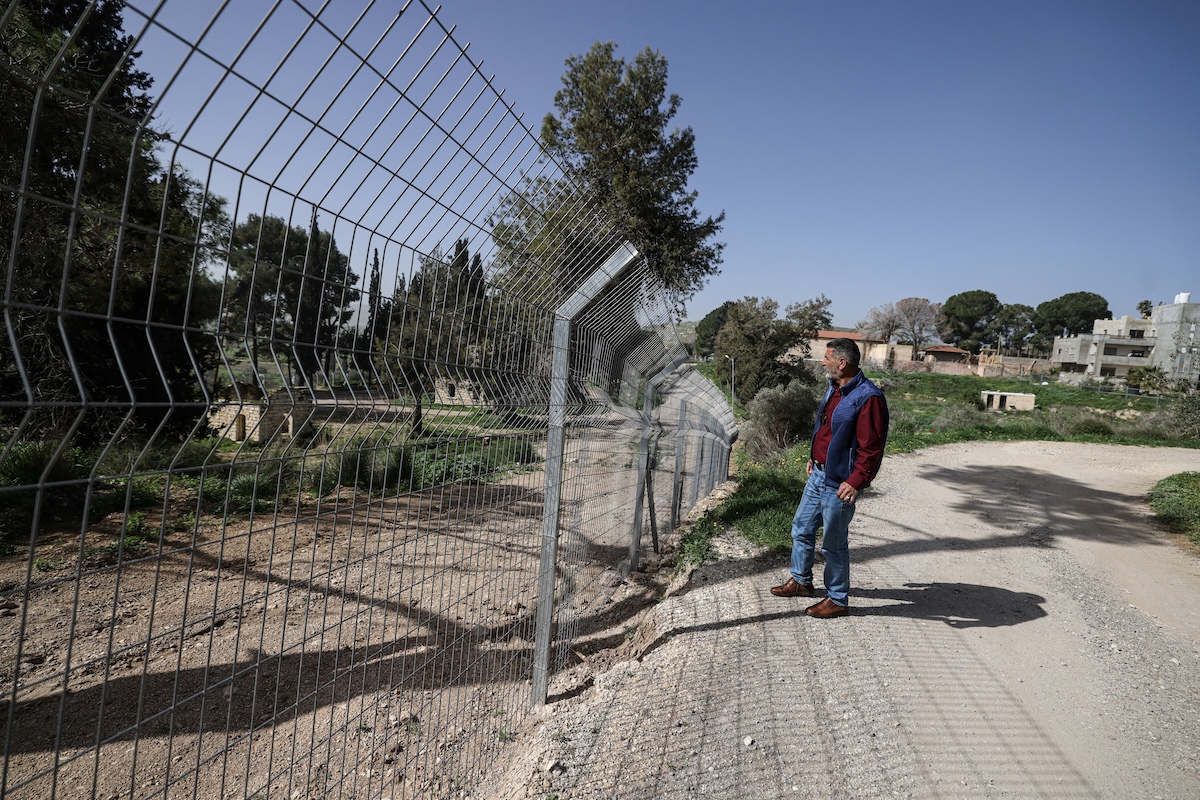 Palestinian Ameed Dusouki, a member of the Burqa village council, stands at a fence installed by Jewish settlers after they announced their control over the historical Al-Masoudiya Ottoman era train station, which operated between the Palestinian cities of Nablus and Tulkarm in the 1920s, just north of the city of Nablus, in the northern Israeli-occupied West Bank on February 15, 2026. (FILE/AFP)
