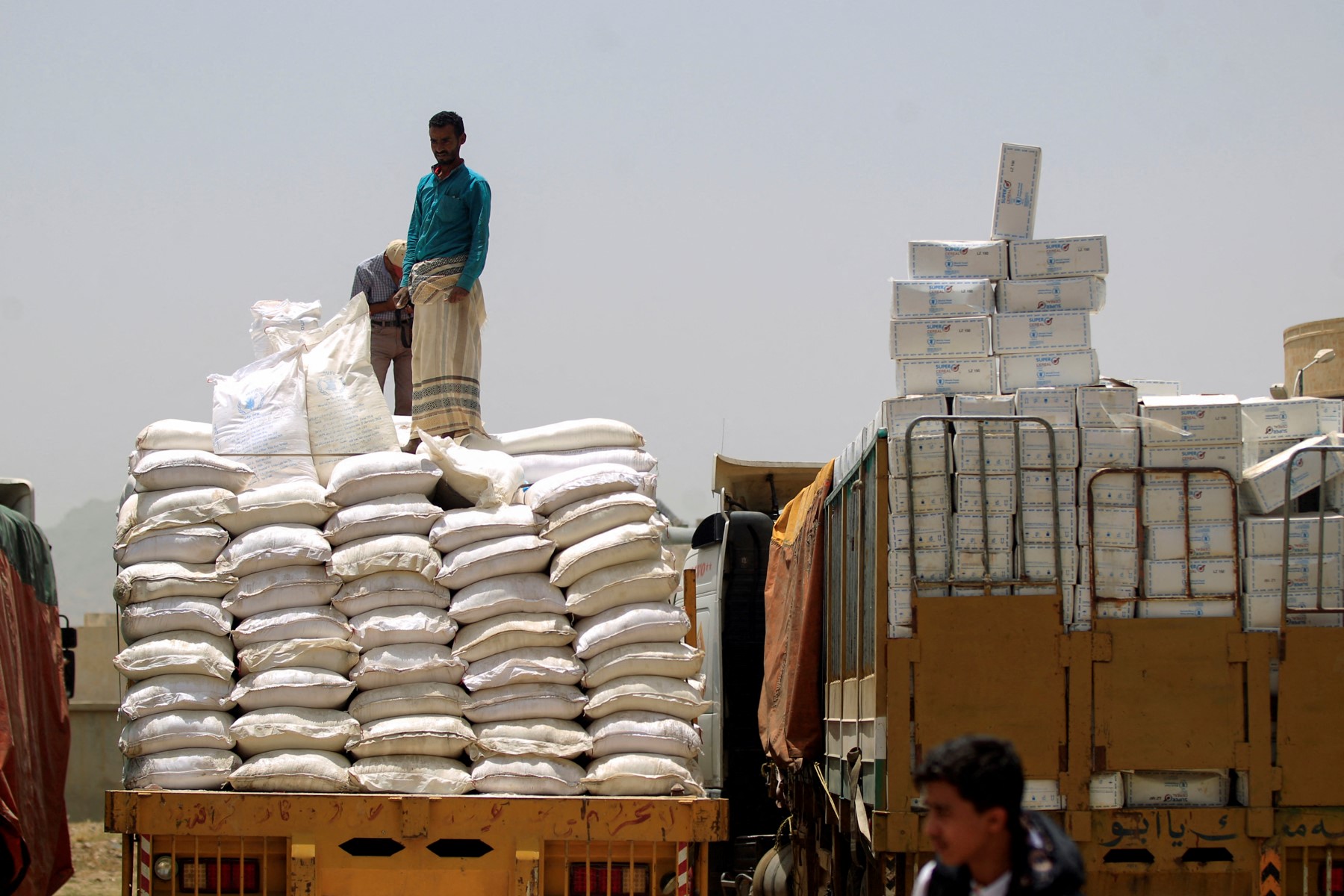 Yemenis inspect food and medicine expired aid packages from the World Food Organisation in the Huthi-rebel-held Yemeni capital Sanaa on June 23, 2019. (File/AFP)