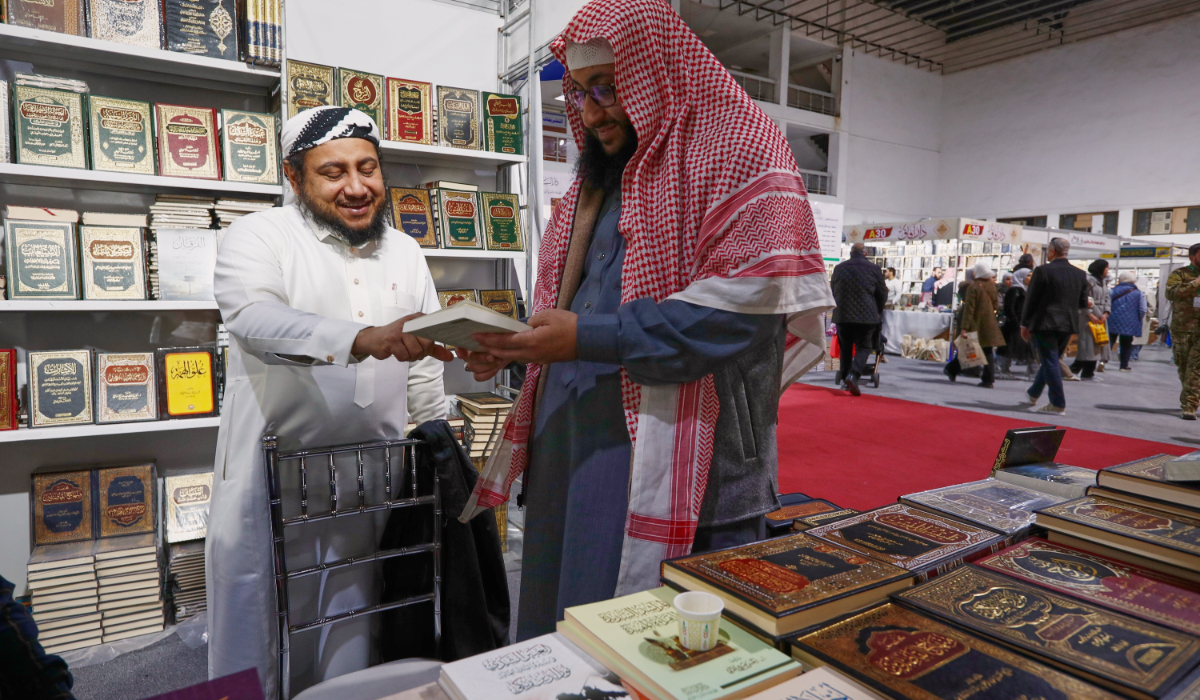 A visitor looks through a book at a stall selling Islamic titles during the 57th Damascus International Book Fair in Damascus, Syria, Monday, Feb. 16, 2026, the first edition since the collapse of the Assad regime. (AP)