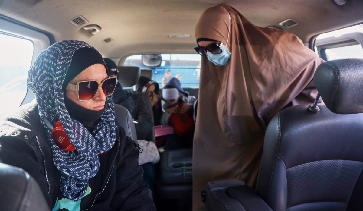 Family members of suspected Islamic State militants who are Australian nationals board a van heading to the airport in Damascus during the first repatriation operation of the year, at Roj Camp in eastern Syria, Monday, Feb. 16, 2026. (AP)
