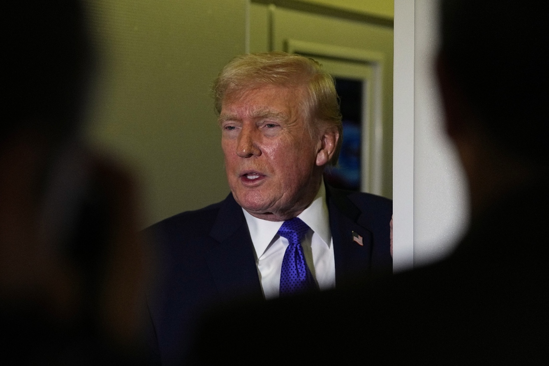 President Donald Trump speaks with reporters aboard Air Force One. (AP)
