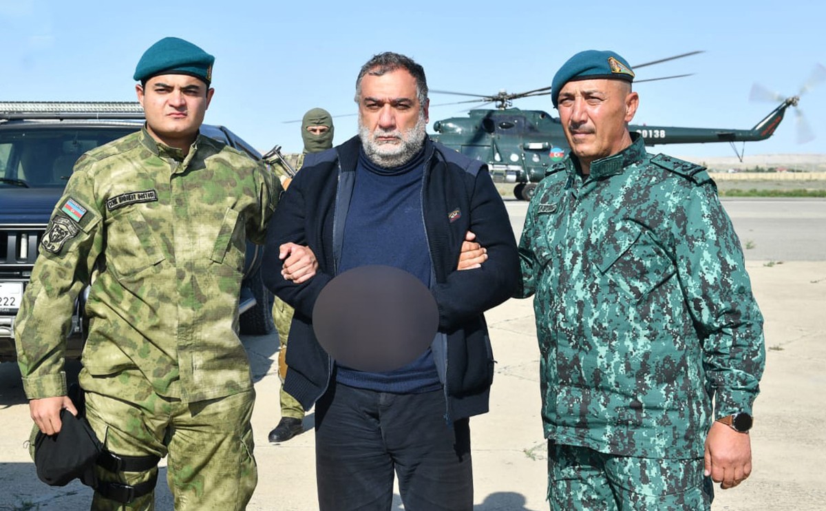 This handout photograph released by State Border Service of Azerbaijan on September 27, 2023, shows Ruben Vardanyan, a former separatist head of Nagorno-Karabakh, detained by two Azerbaijani security officers.