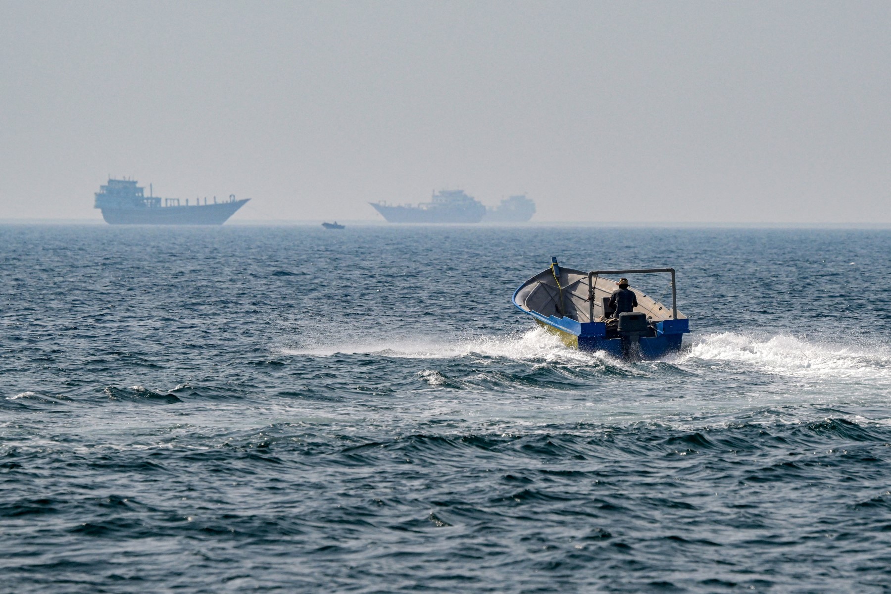 A boat sails in the waters of the Strait of Hormuz off Khasab in Oman’s northern Musandam peninsula on June 25, 2025. (AFP)
