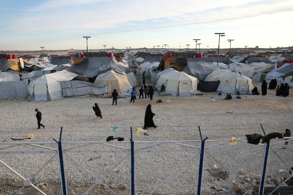 Children and women, relatives of suspected Islamic State jihadists, walk inside Al-Hol camp in the desert region of Syria's northeastern Hasakeh province on January 21, 2026. (File/AFP)
