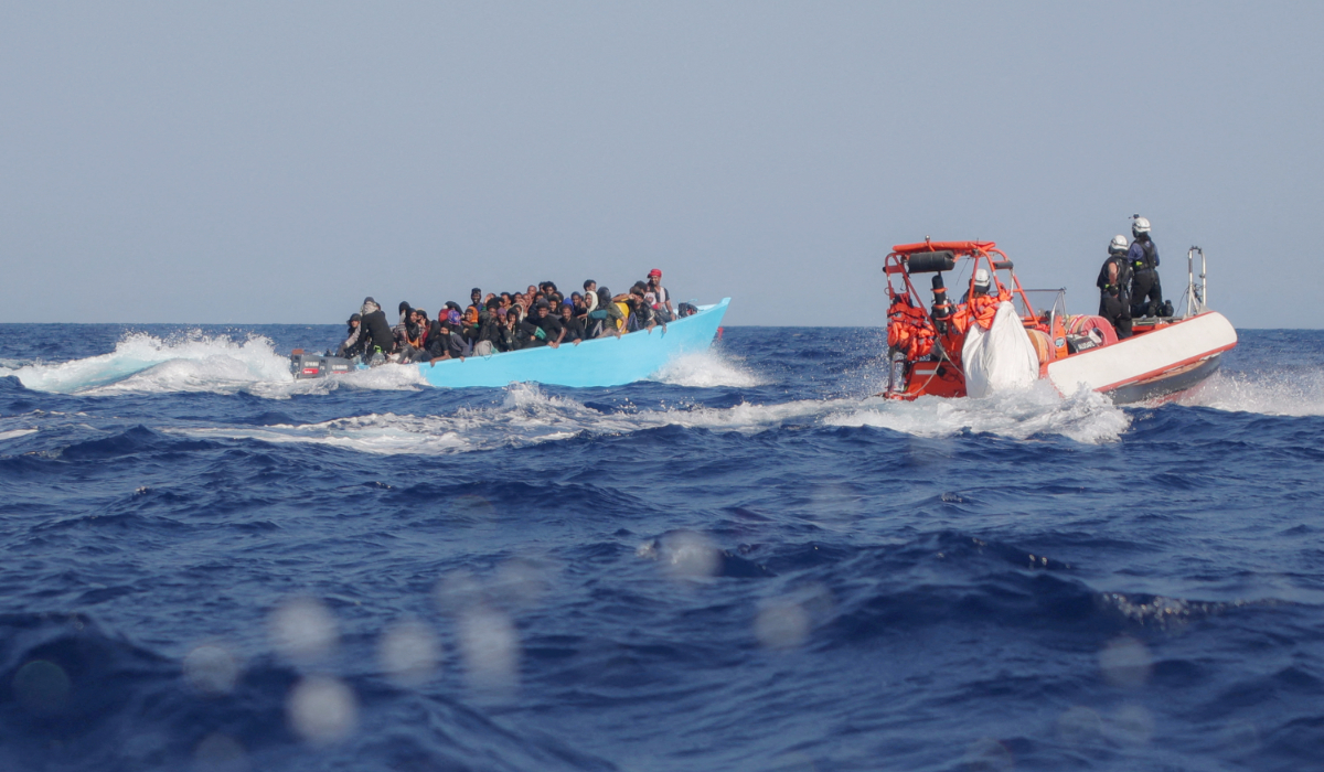 Migrants aboard an overcrowded boat are approached by the crew of the migrant search and rescue ship Sea-Watch 5, operated by the German NGO Sea-Watch, during a rescue operation in the Search and Rescue (SAR) zone in the central Mediterranean, off Libya, August 11, 2025. (REUTERS)