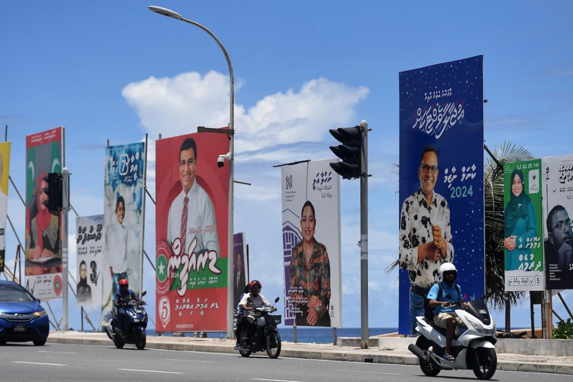 Motorists ride pastel ection hoardings of candidates for Maldives' upcoming parliamentary elections, in Male on April 17, 2024. (FILE/AFP)