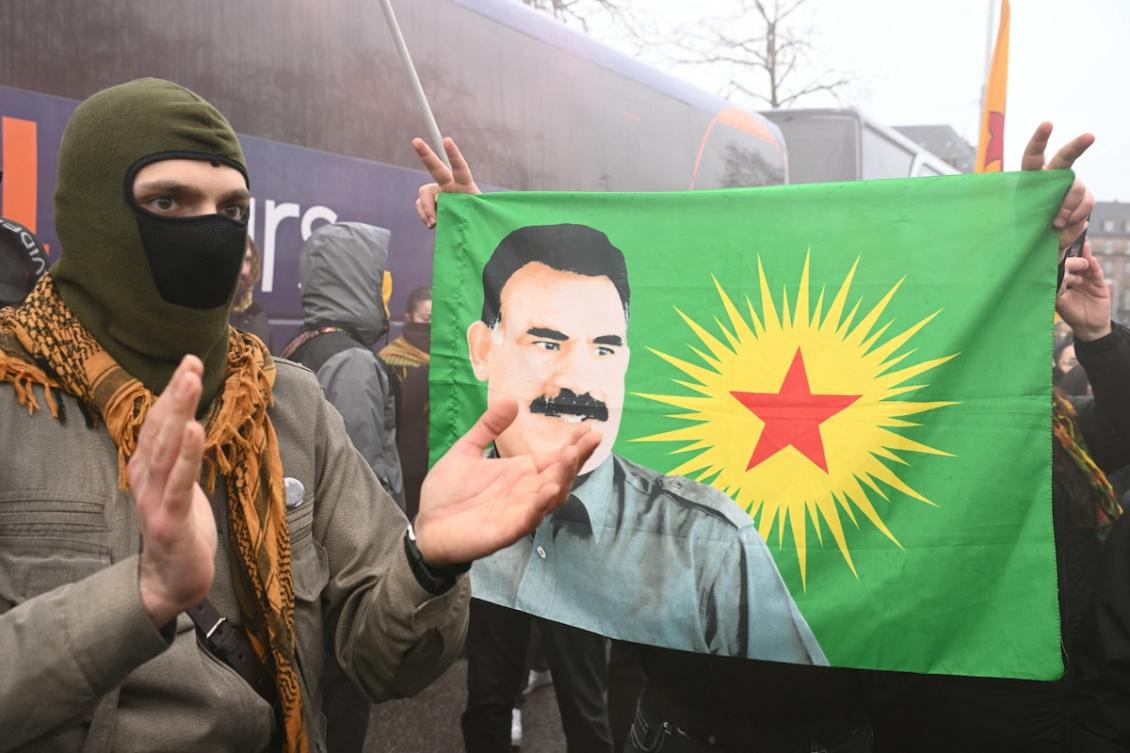 Protestors hold a flag bearing a portrait of jailed leader of the Kurdistan Workers' Party (PKK) Abdullah Ocalan during a demonstration of Kurdish people from all around Europe to mark the 27th anniversary of his arrest and to demand his liberation, in Strasbourg, Eastern France, on February 14, 2026. (FILE/AFP)