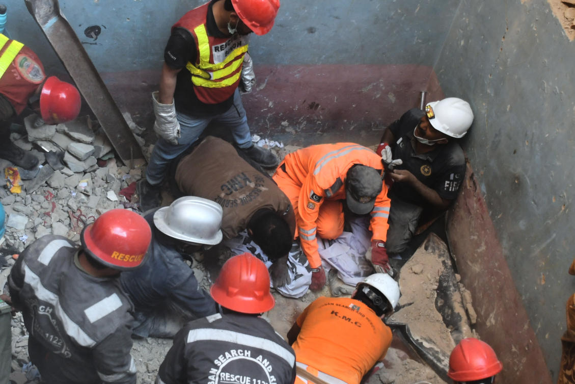Rescue workers recover a body from the rubble following a gas explosion in an apartment building in Karachi, Pakistan, Thursday, Feb. 19, 2026. (AP)