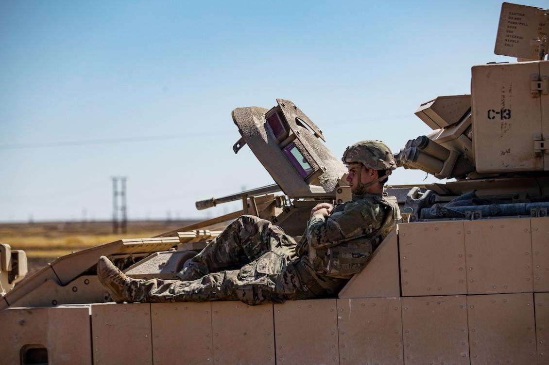 A US soldier rests on a tank as troops patrol oil fields near Syria's northeastern border with Turkey in the Qahtaniyah countryside in the far northeast corner of Hasakeh province on September 3, 2024. (FILE/AFP)