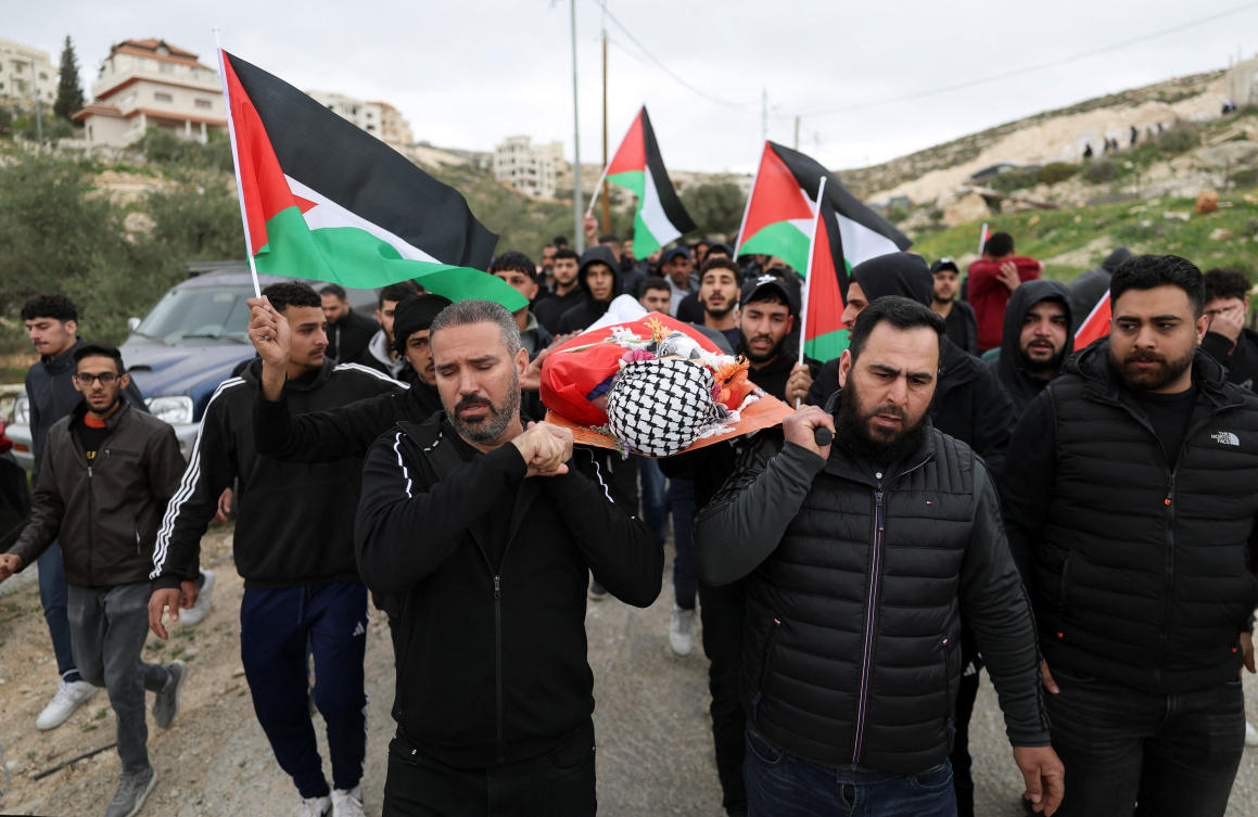 Mourners carry the body of a Palestinian, Nasrallah Muhammad Jamal Abu Siam, 19, who, according to the Palestinian Ministry of Health was killed by an Israeli settler, during his funeral in the town of Mikhmas, near Ramallah in the Israeli-occupied West Bank, February 19, 2026. (REUTERS)