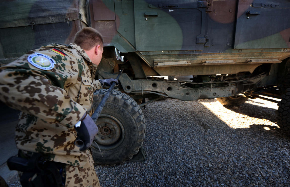 German military experts work on an army vehicle at a workshop for Peshmerga forces on February 18, 2016. (File/AFP)
