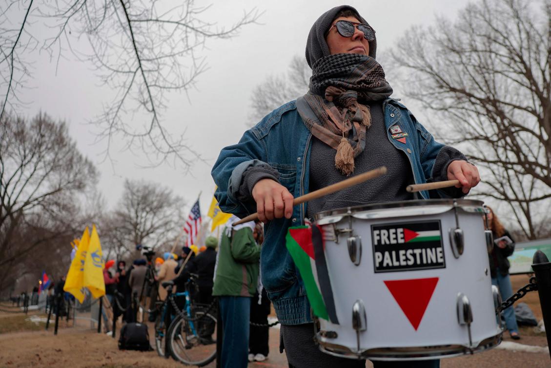 Anti-Trump and pro-Palestine protesters gather outside the Donald J. Trump Institute of Peace on Feb. 19, 2026 in Washington. (AFP)